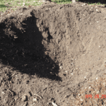 A hole in the ground with dirt in it.